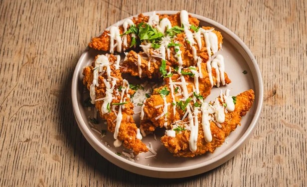 Garlic Parmesan Tenders Tenders drizzled with our roasted garlic aioli. Garnished with freshly grated parmesan and parsley